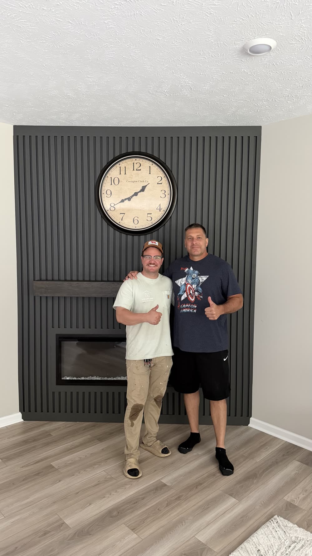 Square One Home Solutions crew in front of a finished black slat accent wall